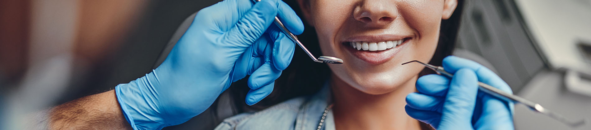An image featuring a person receiving dental care with visible tools and a smiling expression.
