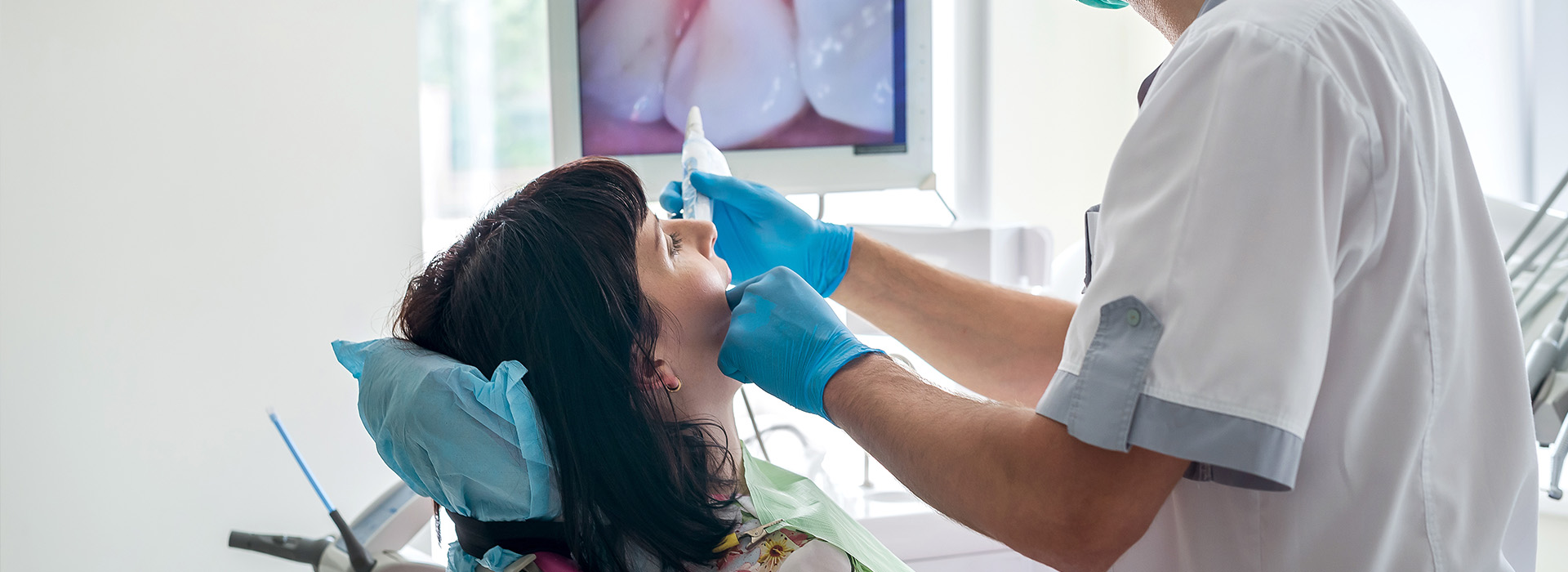 A dental professional performing a dental procedure on a patient.
